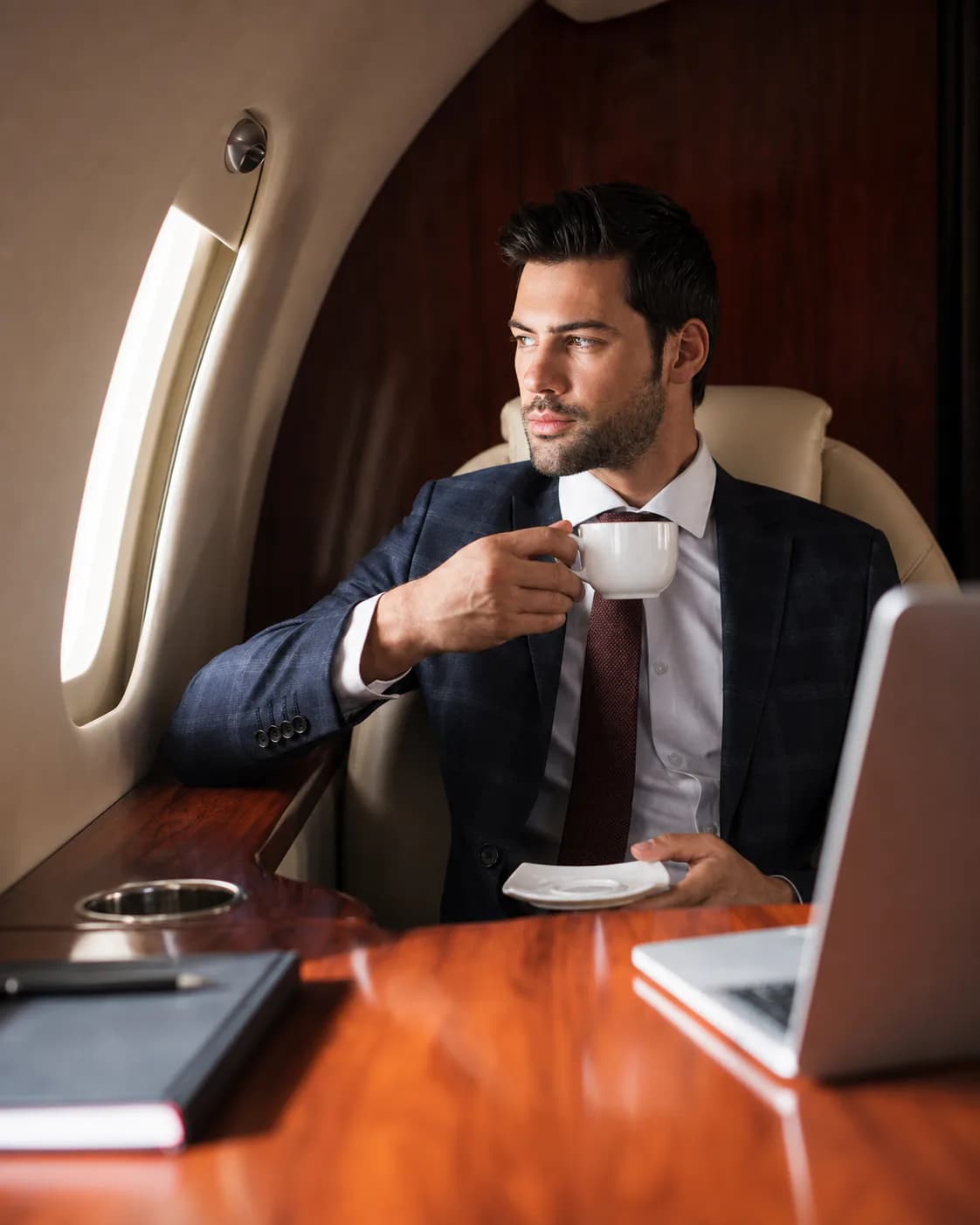 Businessman having coffee on a flight